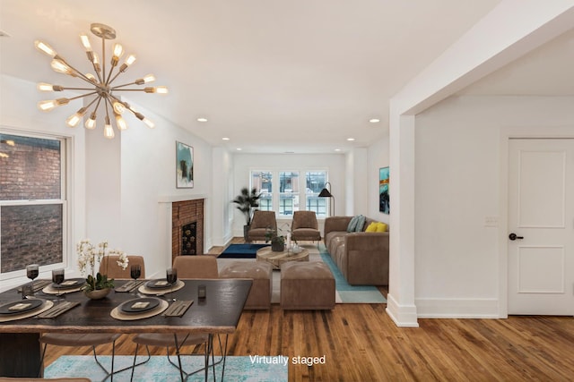 449 W Willis St Unit 4, Detroit, MI 48201 - living room with recessed lighting, wood finished floors, a fireplace, baseboards, and a chandelier