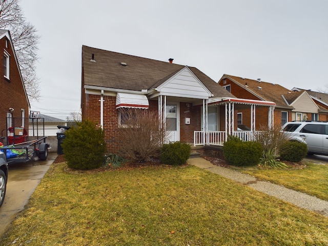 bungalow featuring a porch and a front lawn