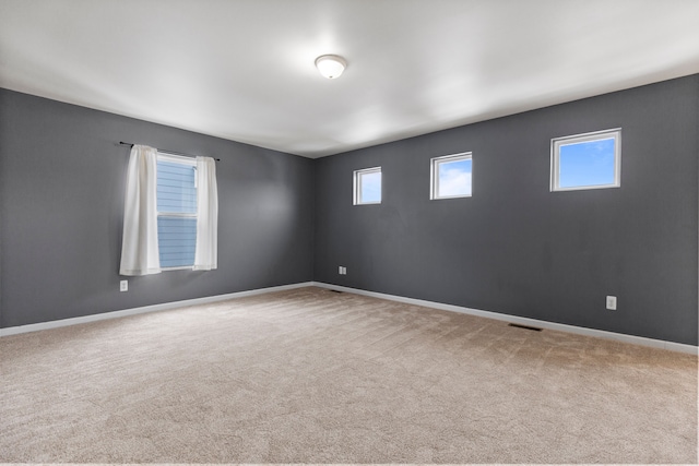 unfurnished room with light carpet