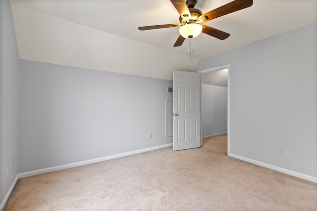 interior space with light carpet, vaulted ceiling, and ceiling fan