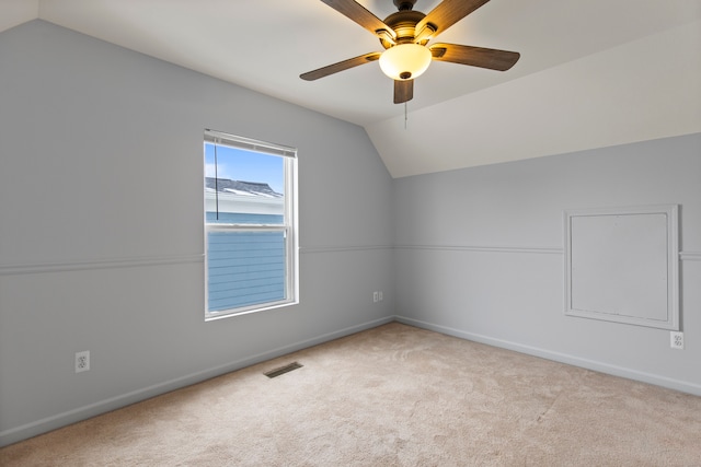 additional living space with light carpet, lofted ceiling, and ceiling fan