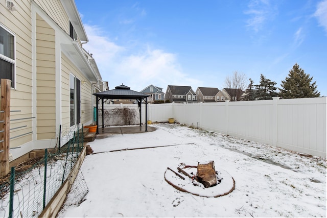 snow covered patio featuring a gazebo