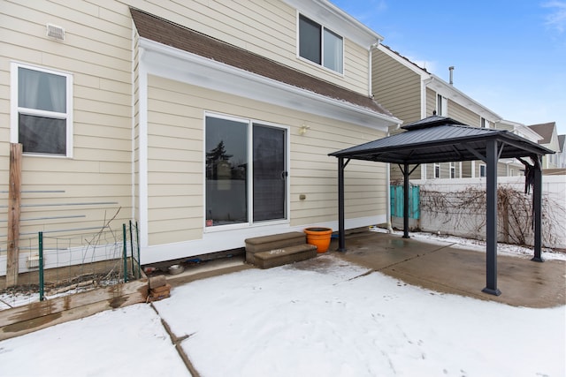 snow covered patio featuring a gazebo