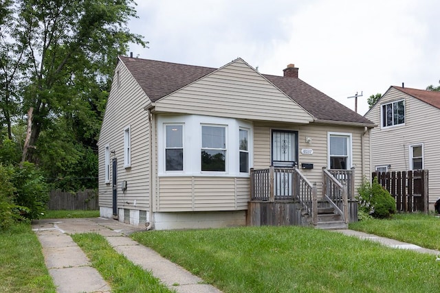 bungalow-style house with a front lawn