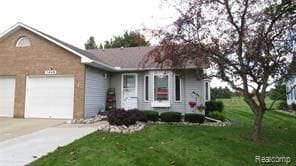 view of front of house with a garage and a front yard