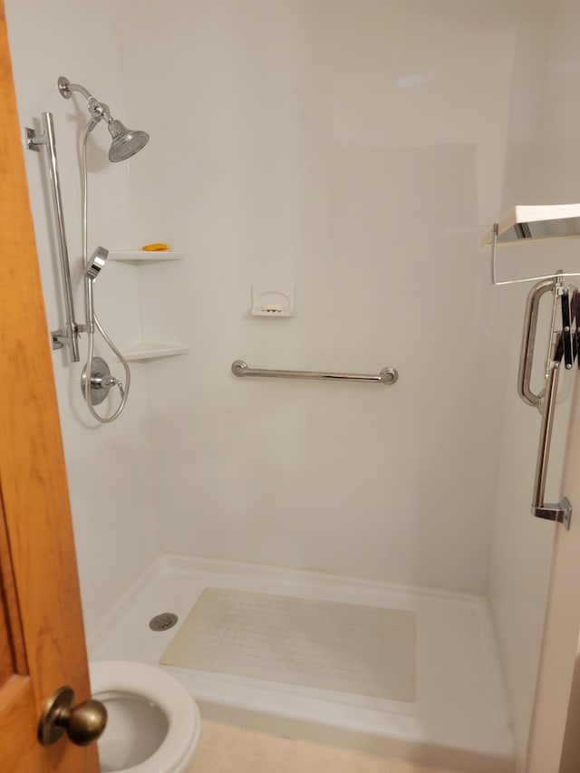 bathroom featuring toilet and a shower