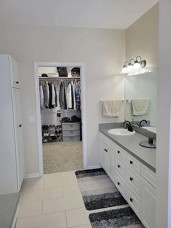 bathroom featuring tile patterned flooring and vanity