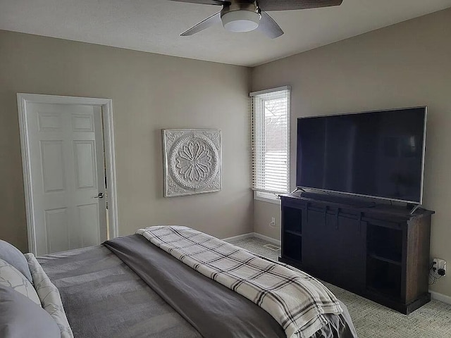 bedroom featuring light colored carpet and ceiling fan