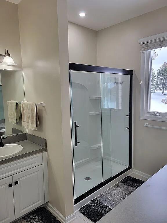 bathroom with vanity and an enclosed shower