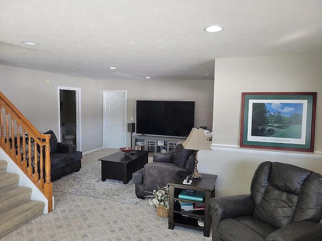 living room featuring light colored carpet and a textured ceiling