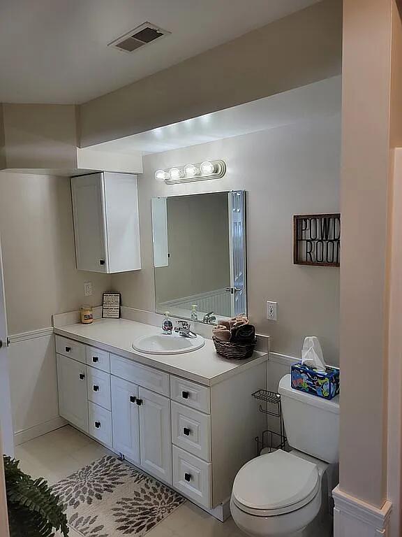 bathroom featuring vanity and toilet