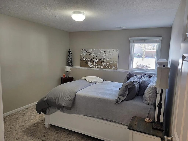 carpeted bedroom featuring a textured ceiling