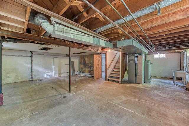 basement featuring gas water heater and heating unit