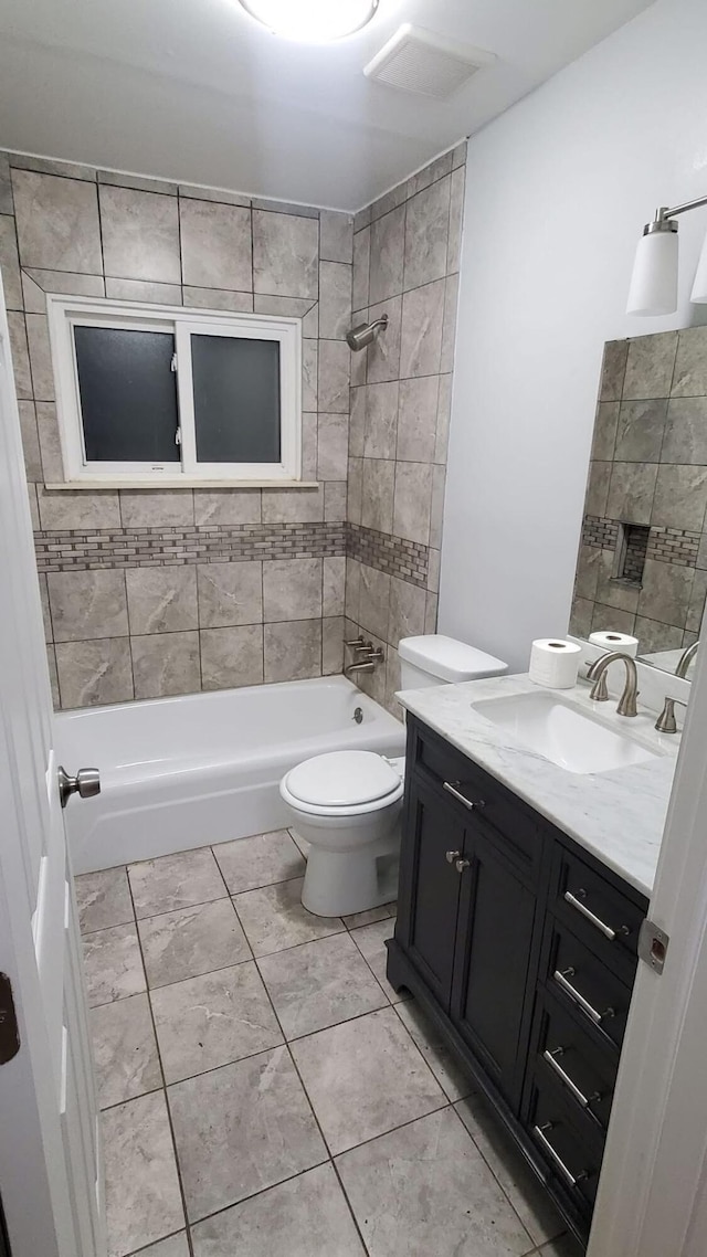 full bathroom with tiled shower / bath combo, vanity, and toilet