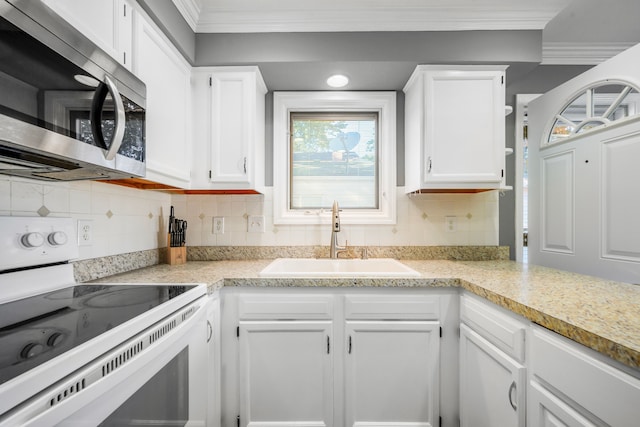 kitchen featuring sink, crown molding, white electric range oven, tasteful backsplash, and white cabinets