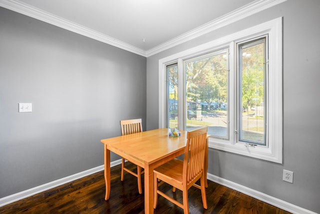 dining room featuring crown molding and dark wood-type flooring