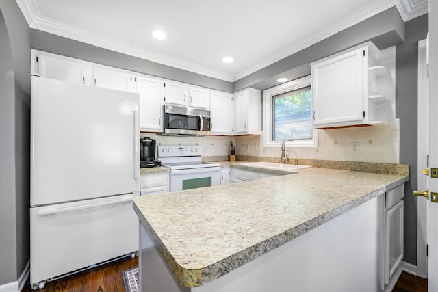 kitchen with white cabinetry, white appliances, tasteful backsplash, and kitchen peninsula