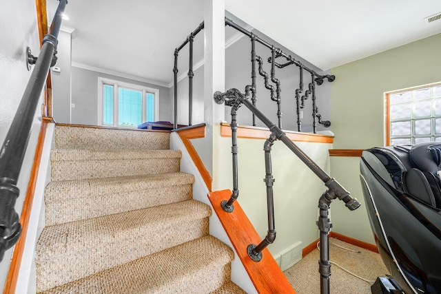 stairway featuring ornamental molding