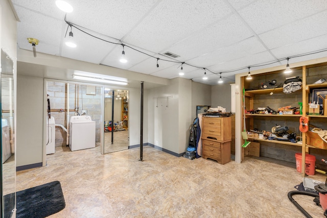 basement with independent washer and dryer and a paneled ceiling