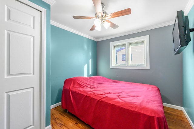 bedroom featuring crown molding, ceiling fan, and dark hardwood / wood-style flooring