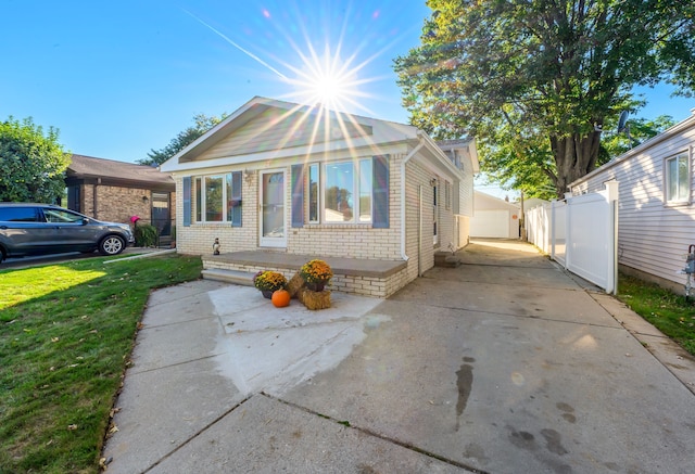 bungalow with a garage and a front lawn