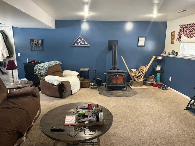 playroom featuring carpet and a wood stove