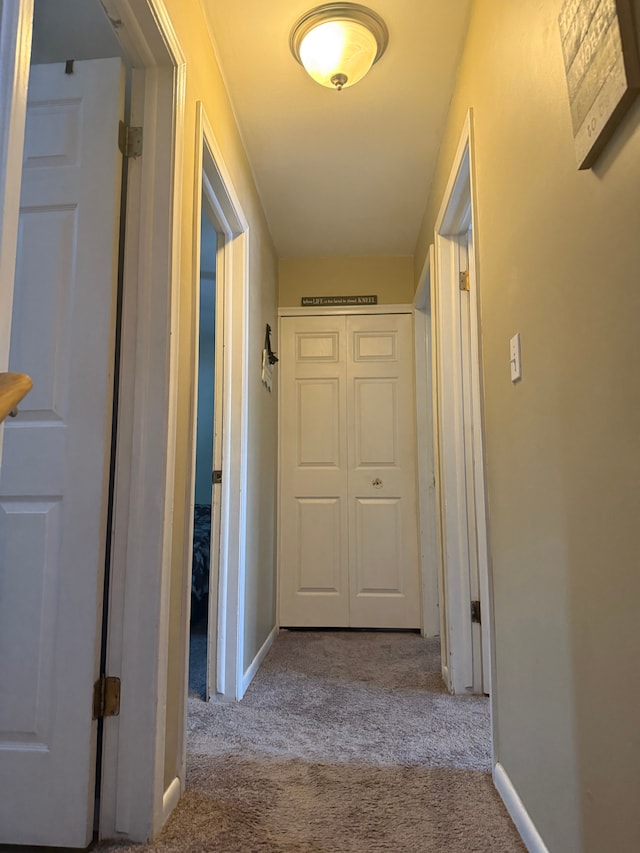 hall with light colored carpet