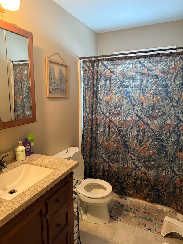 bathroom with vanity, tile patterned floors, toilet, and a shower with shower curtain