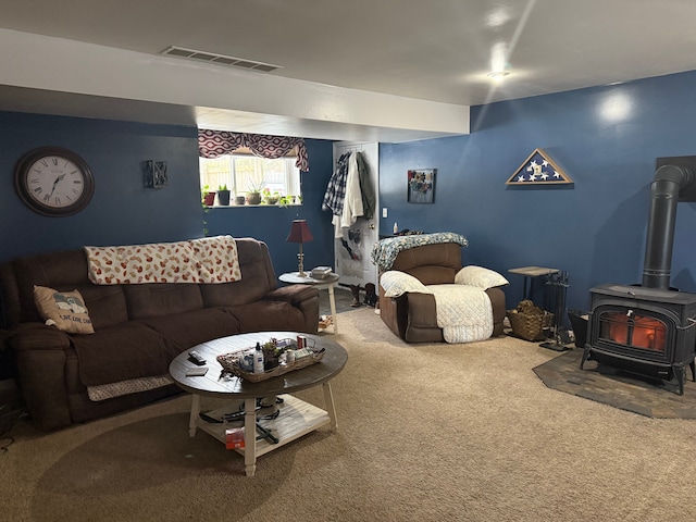 living room with carpet flooring and a wood stove