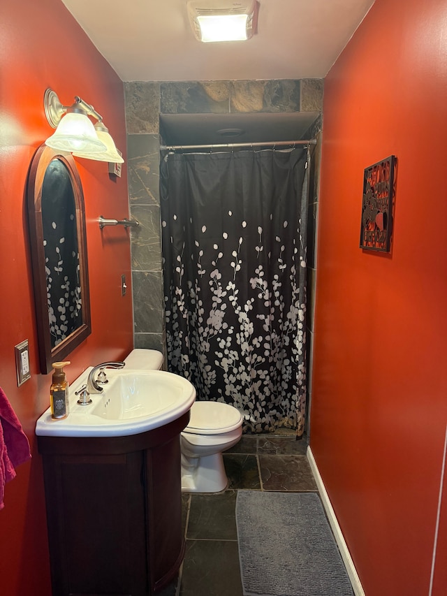 bathroom featuring vanity, curtained shower, and toilet