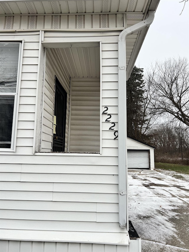 view of side of property featuring an outbuilding and a garage