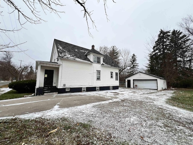 view of side of home featuring a garage and an outdoor structure