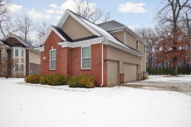 view of snow covered exterior featuring a garage