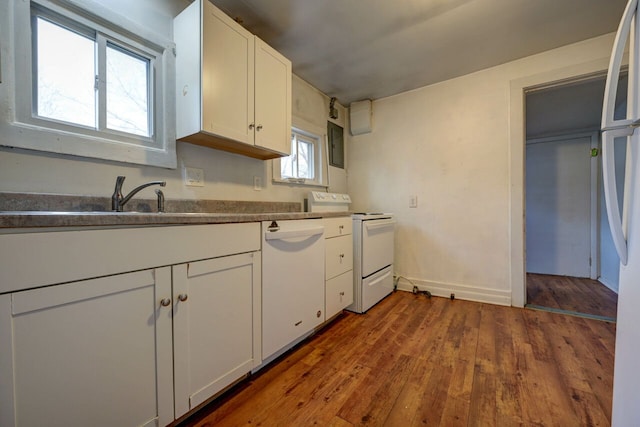 kitchen featuring white appliances, dark hardwood / wood-style flooring, sink, and white cabinets