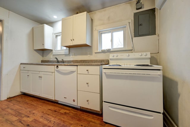 kitchen featuring white cabinetry, sink, hardwood / wood-style flooring, electric panel, and white appliances