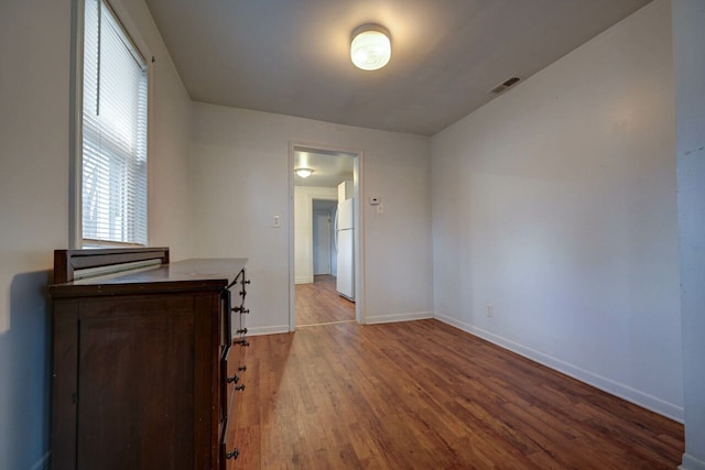 spare room featuring wood-type flooring