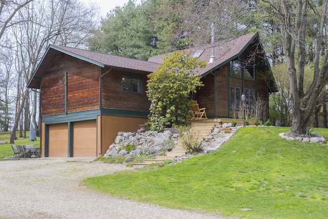 view of front of home featuring a garage and a front lawn