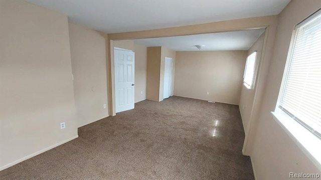 carpeted spare room with a wealth of natural light