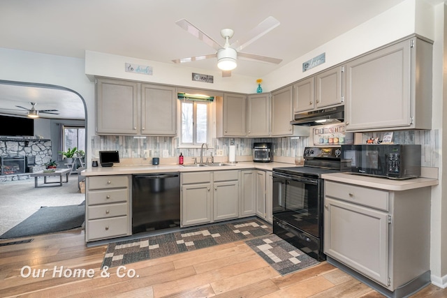 kitchen with tasteful backsplash, sink, gray cabinetry, ceiling fan, and black appliances