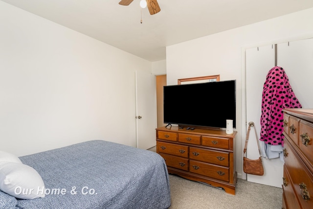 bedroom featuring ceiling fan and light carpet