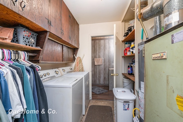 washroom with heating unit, cabinets, and washing machine and clothes dryer