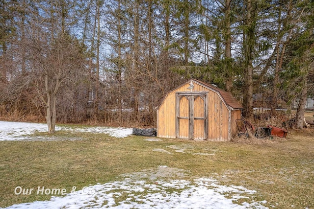 snow covered structure featuring a lawn