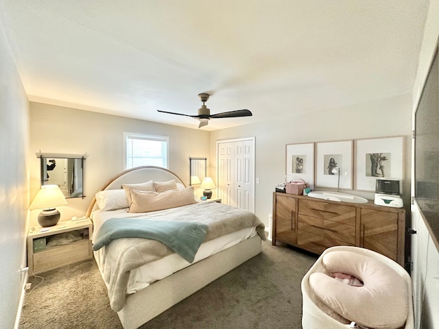 carpeted bedroom featuring ceiling fan and a closet