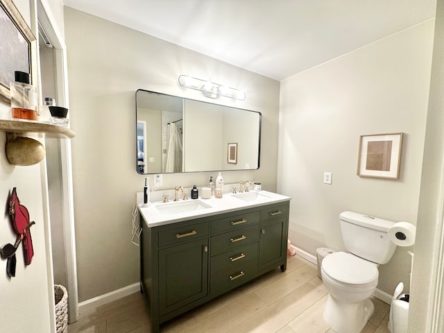 bathroom featuring vanity, walk in shower, and toilet