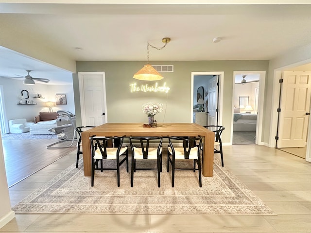 dining area with hardwood / wood-style flooring and ceiling fan