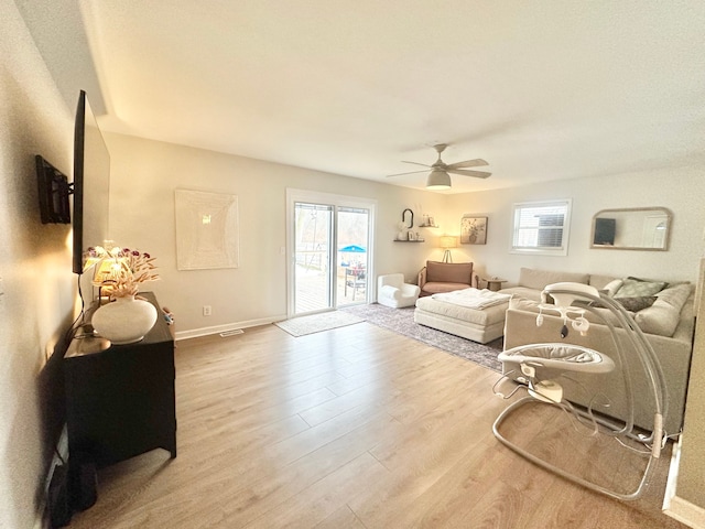 living room with hardwood / wood-style flooring and ceiling fan