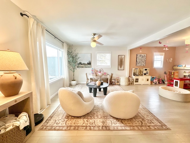 living area featuring ceiling fan