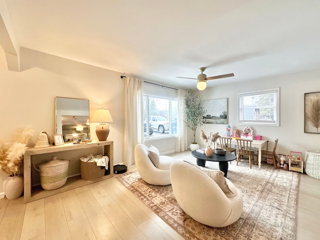 sitting room with hardwood / wood-style flooring and ceiling fan