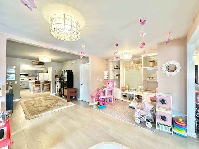 playroom with light hardwood / wood-style flooring