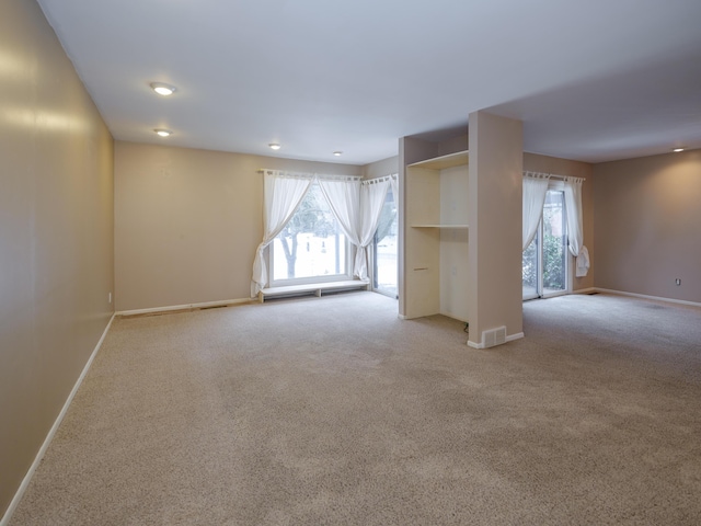 unfurnished room with light colored carpet